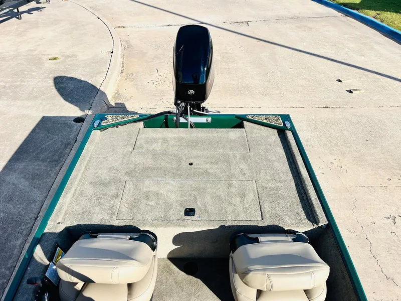 Slide: The Image of 2026 Tracker Bass Tracker Classic Limited boat interior with motor and seating. - 31