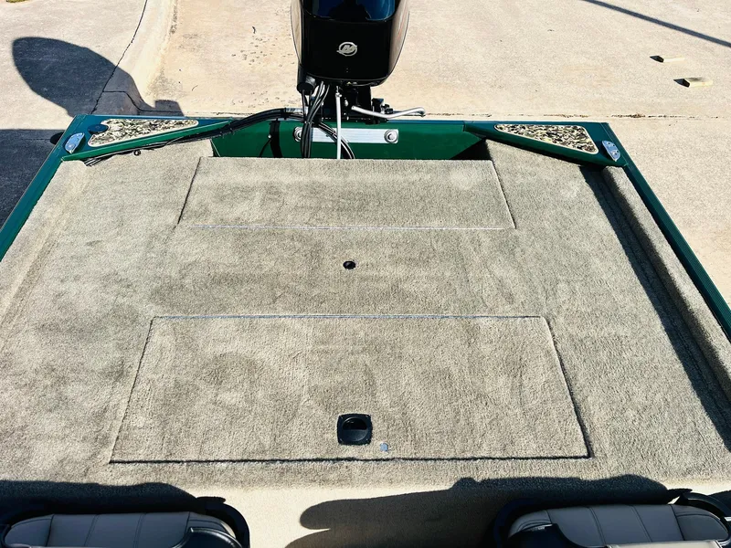 Slide: The Image of 2026 Tracker Bass Tracker Classic Limited boat deck with carpeted surface and motor. - 32