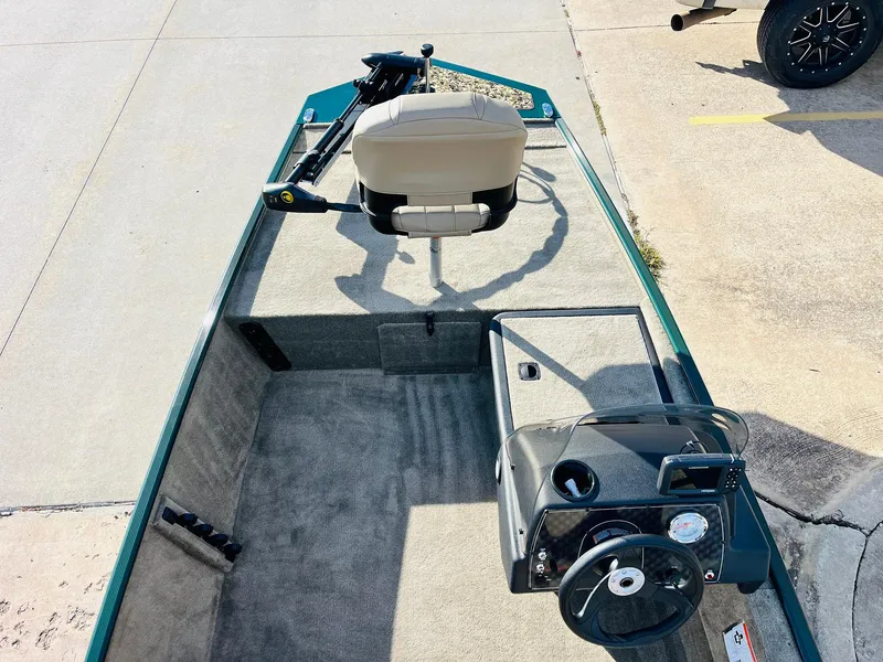 Slide: The Image of 2026 Tracker Bass Tracker Classic Limited boat interior with steering console and seating. - 8