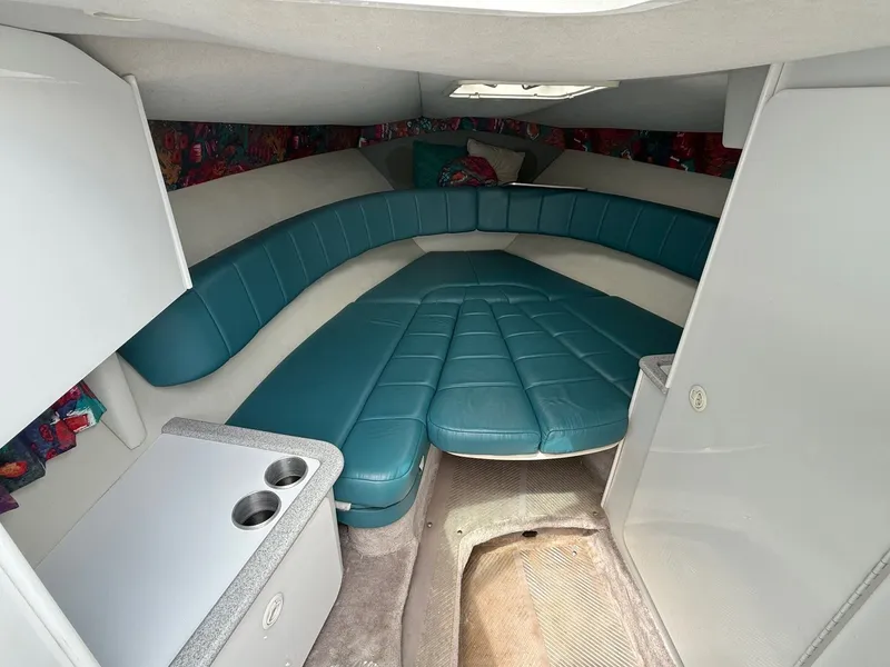 Slide: The Image of 1997 Formula 280SS boat interior with teal seating and compact kitchenette. - 14