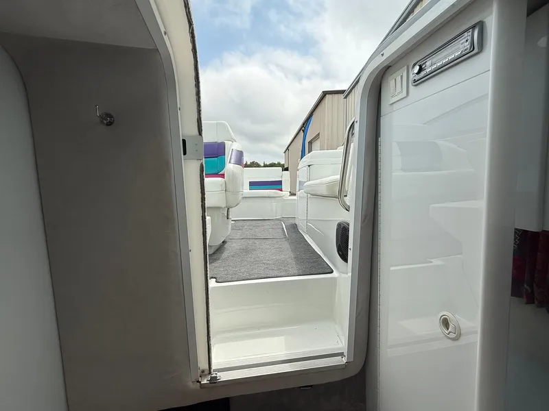 Slide: The Image of 1997 Formula 280SS boat interior with white seating and colorful accents, viewed from cabin entrance. - 17
