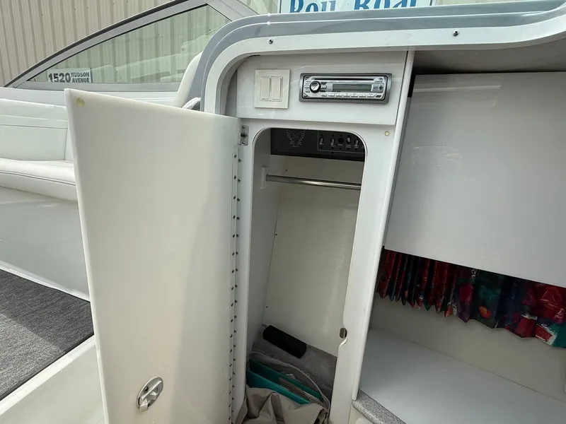 Slide: The Image of 1997 Formula 280SS boat interior with open storage compartment and stereo system. - 18