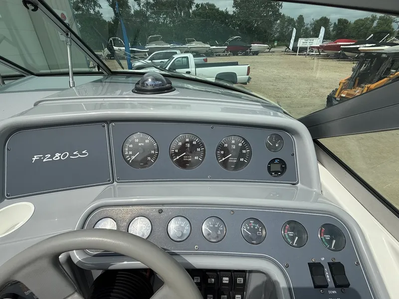 Slide: The Image of Dashboard of a 1997 Formula 280SS boat with gauges and controls. - 23