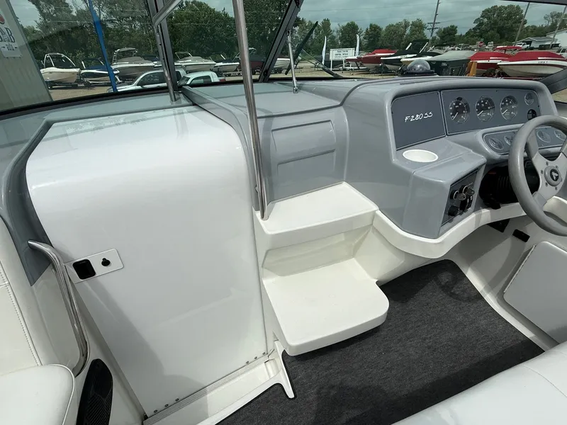 Slide: The Image of 1997 Formula 280SS boat cockpit with steering wheel, dashboard, and seating area. - 28