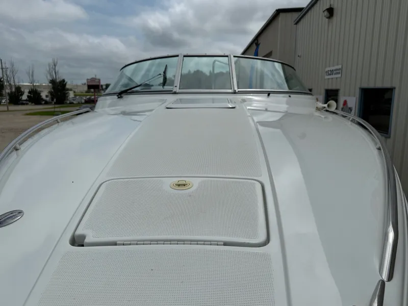 Slide: The Image of 1997 Formula 280SS boat, white deck, docked near industrial building under cloudy sky. - 3