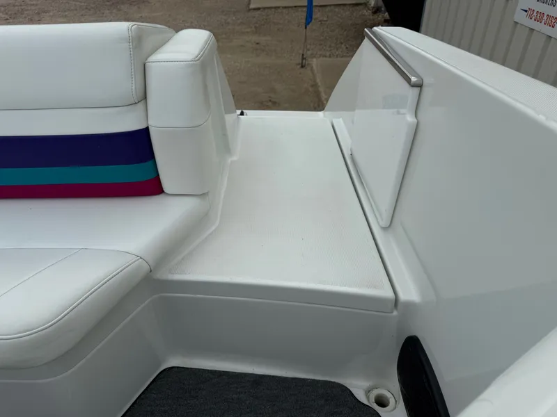 Slide: The Image of 1997 Formula 280SS boat interior with white seating and colorful stripe accents. - 32