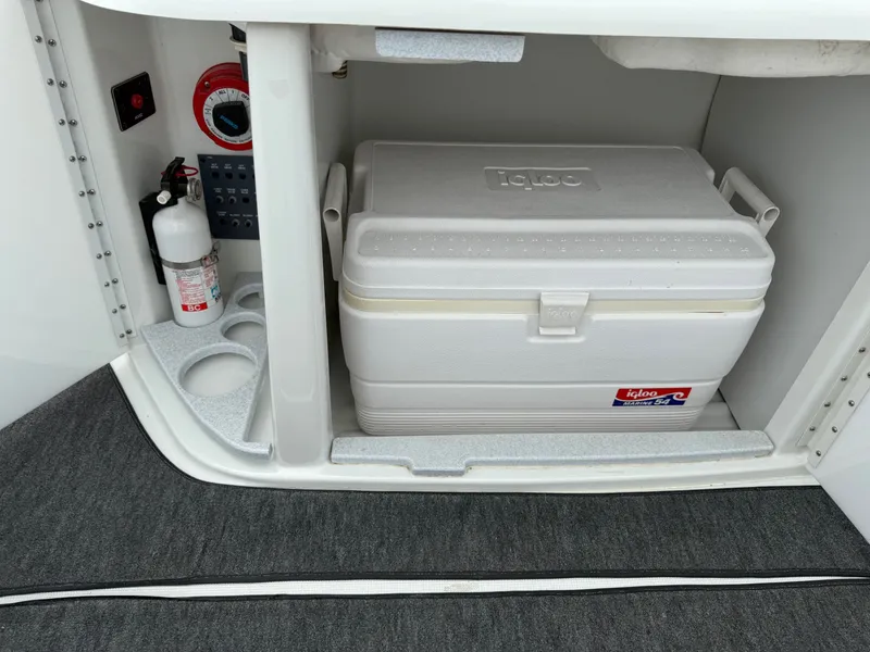 Slide: The Image of 1997 Formula 280SS boat storage with Igloo cooler, fire extinguisher, and control panel. - 34