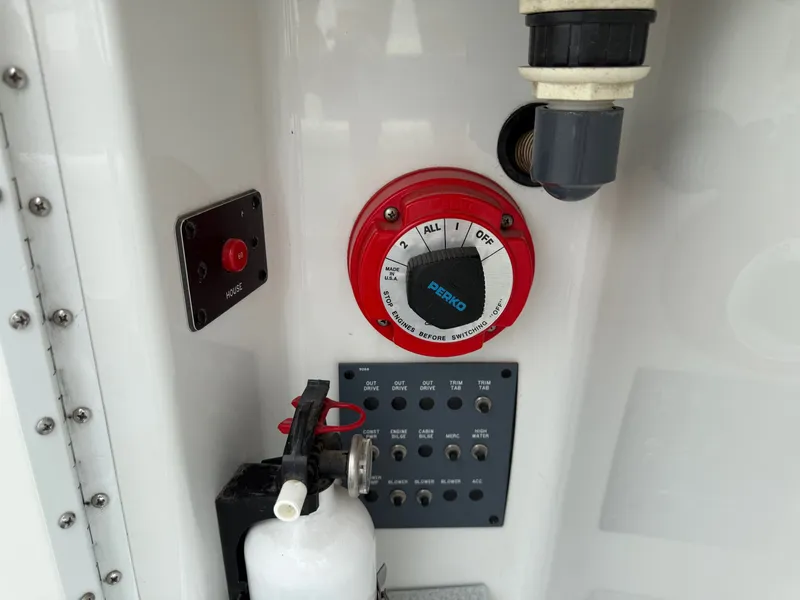 Slide: The Image of Control panel of a 1997 Formula 280SS boat with switches and fire extinguisher. - 35