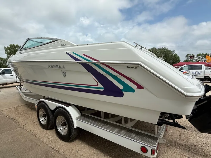 Slide: The Image of 1997 Formula 280SS boat on trailer, featuring colorful graphics and sleek design. - 6
