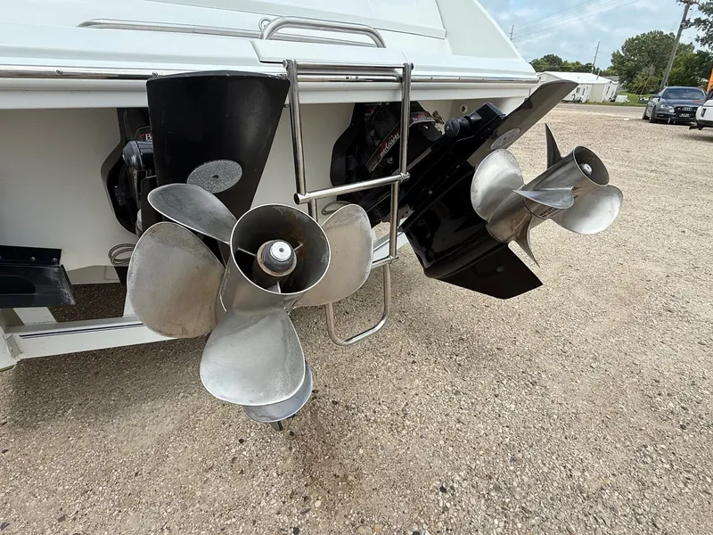 Slide: The Image of 1997 Formula 280SS boat propellers and outdrives on gravel surface. - 7