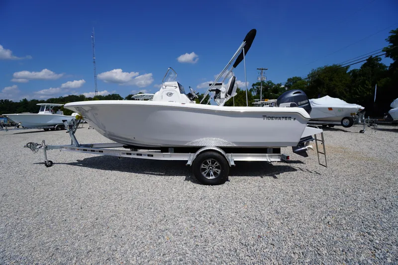The Image of 2025 Tidewater 198 CC Adventure boat on trailer, displayed outdoors under blue sky. - 1