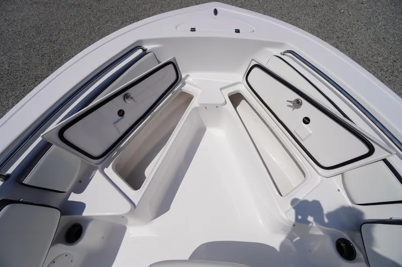 Slide: The Image of 2025 Tidewater 198 CC Adventure boat with open storage compartments. - 11