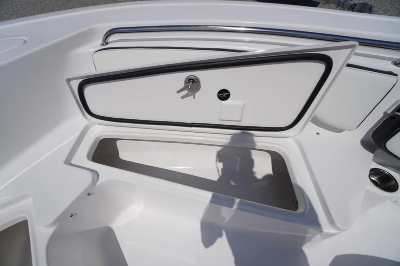 Slide: The Image of 2025 Tidewater 198 CC Adventure boat storage compartment with open hatch and key lock. - 13