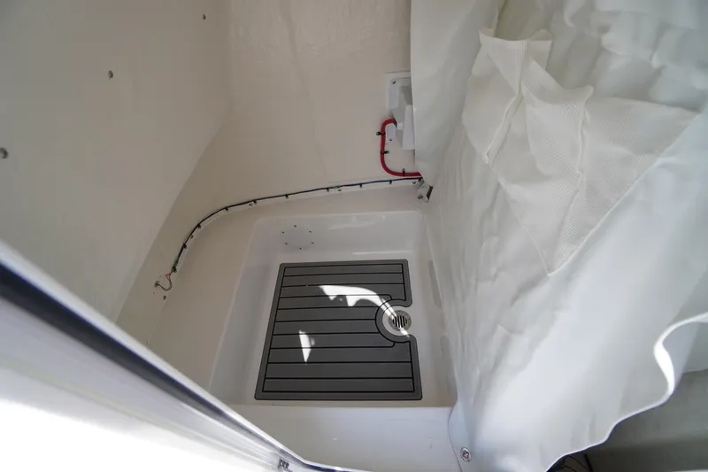 Slide: The Image of Interior view of 2025 Tidewater 198 CC Adventure boat, featuring a compact shower area. - 17