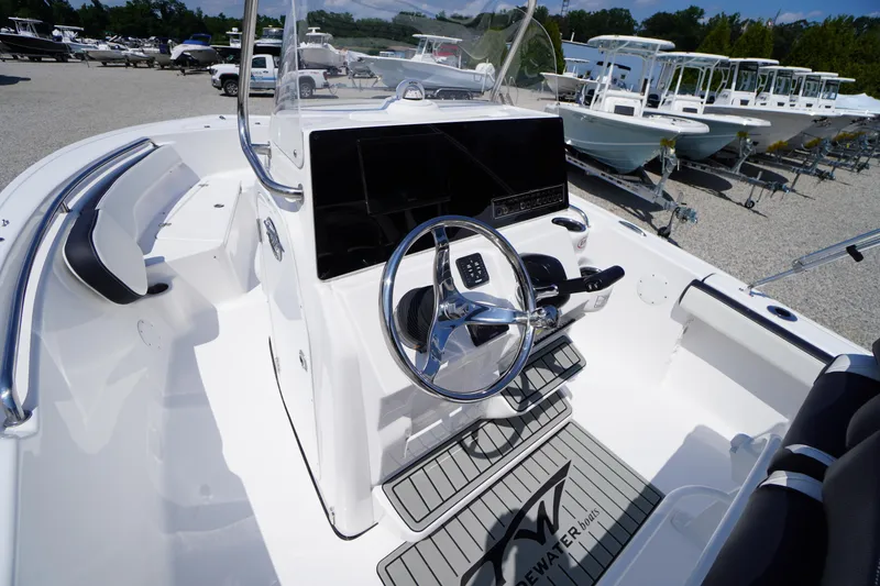Slide: The Image of 2025 Tidewater 198 CC Adventure boat interior with steering wheel and console. - 18