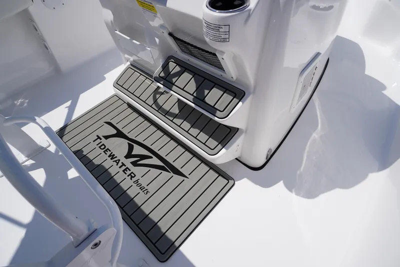 Slide: The Image of 2025 Tidewater 198 CC Adventure boat deck with branded mat and steps. - 23