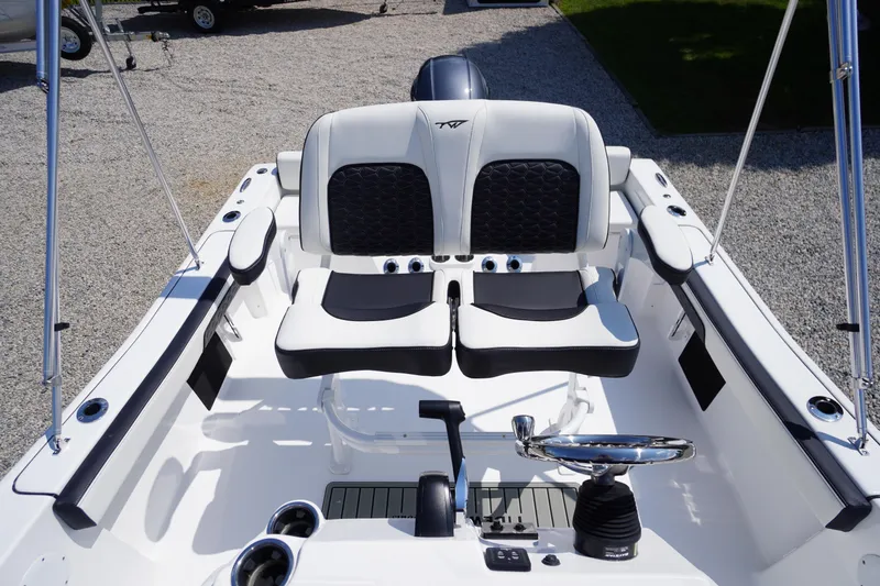 Slide: The Image of 2025 Tidewater 198 CC Adventure boat interior with dual seats and steering wheel. - 24