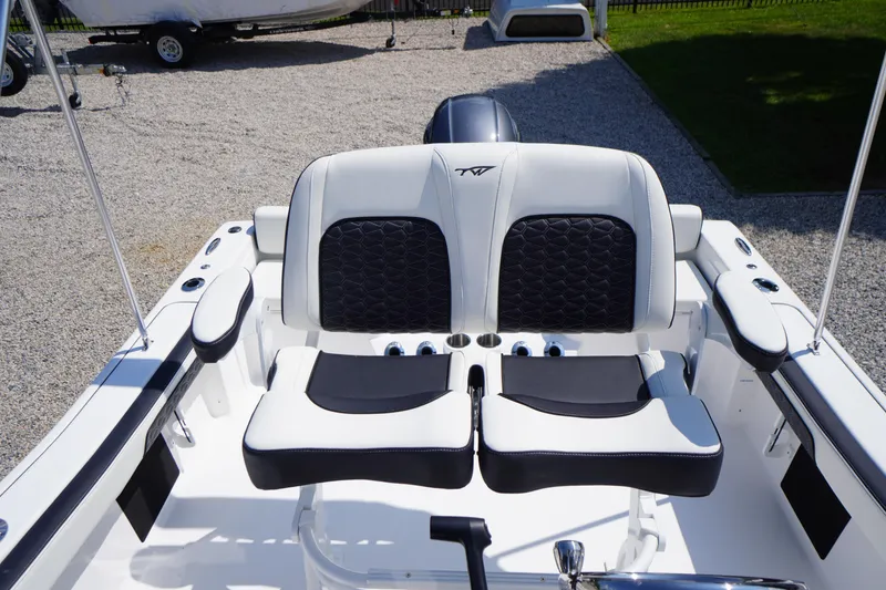Slide: The Image of 2025 Tidewater 198 CC Adventure boat seating with black and white upholstery. - 25