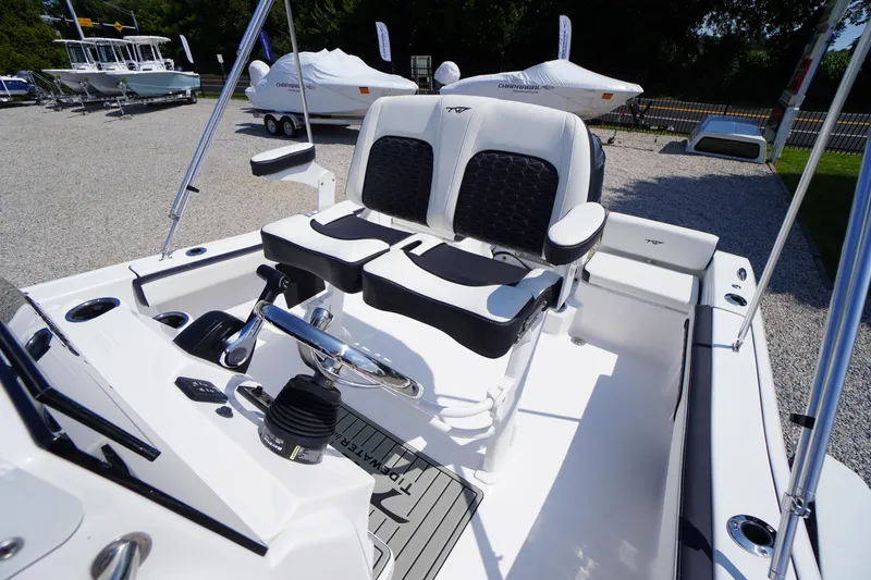 Slide: The Image of 2025 Tidewater 198 CC Adventure boat interior with dual seats and steering console. - 26