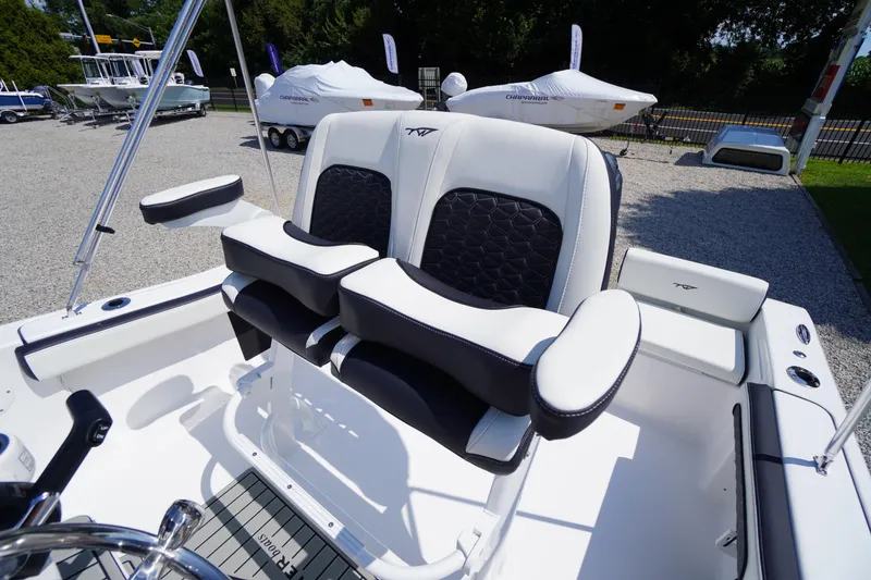 Slide: The Image of 2025 Tidewater 198 CC Adventure boat interior with dual seats and steering wheel. - 27