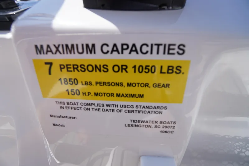Slide: The Image of 2025 Tidewater 198 CC Adventure boat capacity label, 7 persons or 1050 lbs, 150 HP motor. - 29