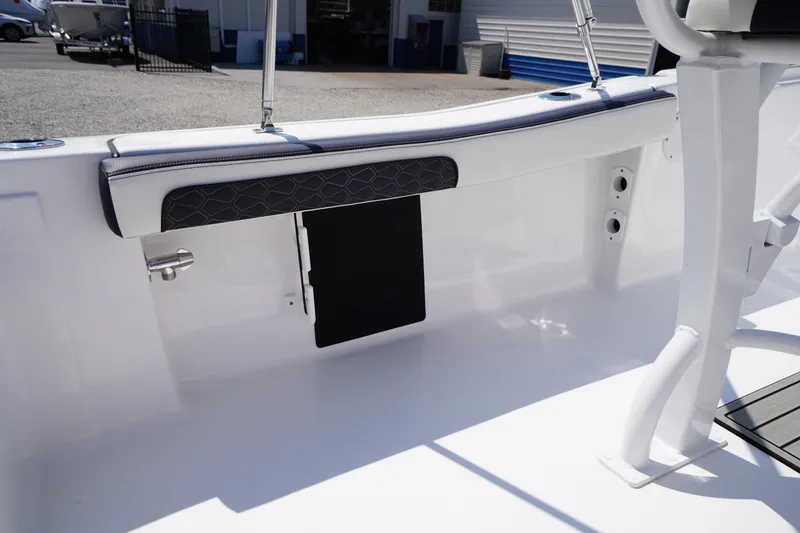 Slide: The Image of 2025 Tidewater 198 CC Adventure boat interior with cushioned seating and storage. - 31