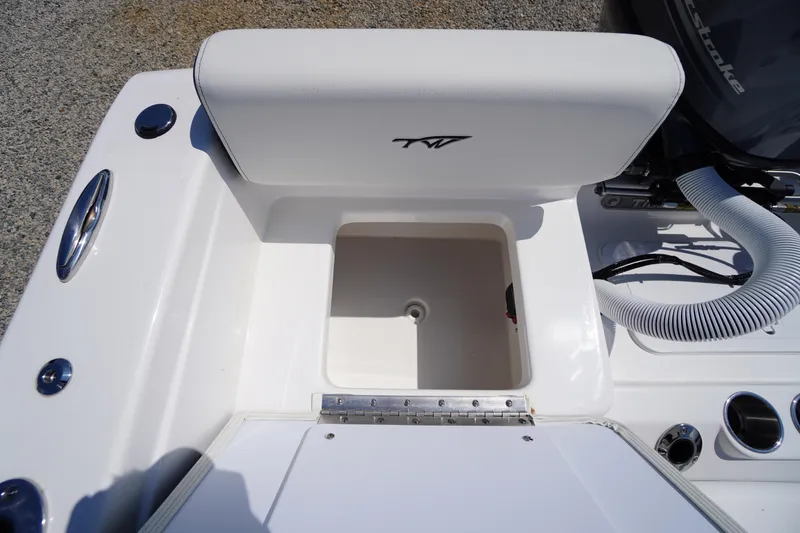 Slide: The Image of 2025 Tidewater 198 CC Adventure boat storage compartment with white cushioned seat. - 35
