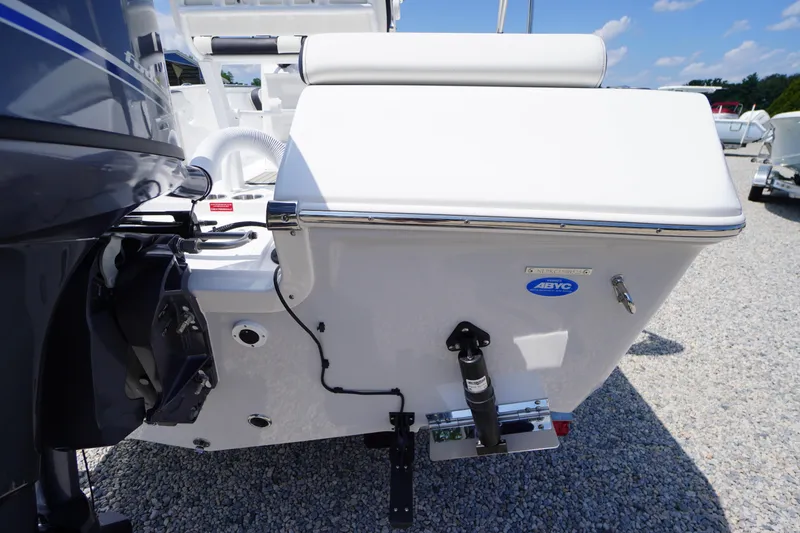 Slide: The Image of 2025 Tidewater 198 CC Adventure boat rear view, showcasing motor and seating on gravel surface. - 38