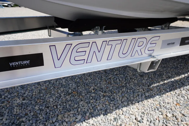 Slide: The Image of Trailer for 2025 Tidewater 198 CC Adventure boat on gravel surface. - 45