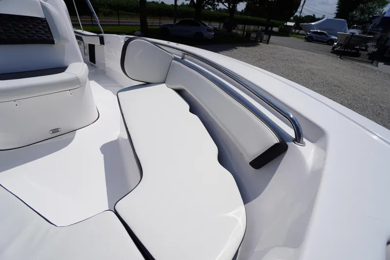 Slide: The Image of 2025 Tidewater 198 CC Adventure boat interior with white cushioned seating and metal railing. - 9