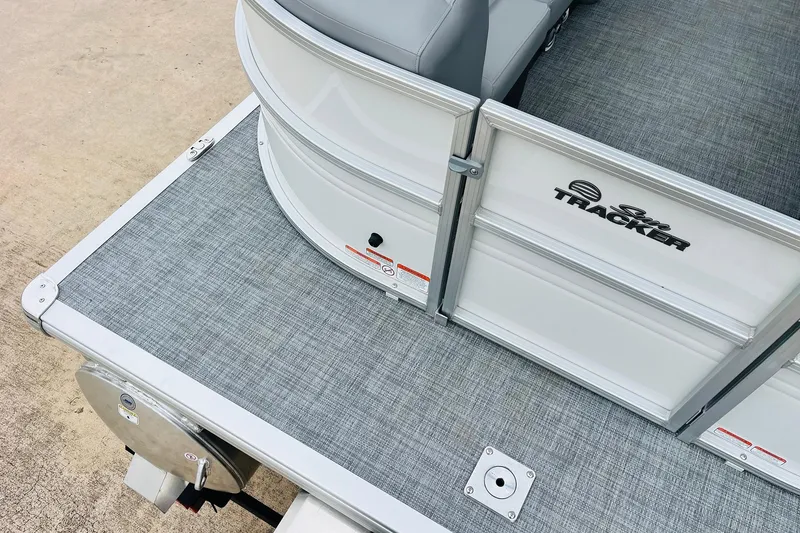 Slide: The Image of 2026 Sun Tracker Party Barge 22 DLX pontoon boat, gray deck, and seating detail. - 12