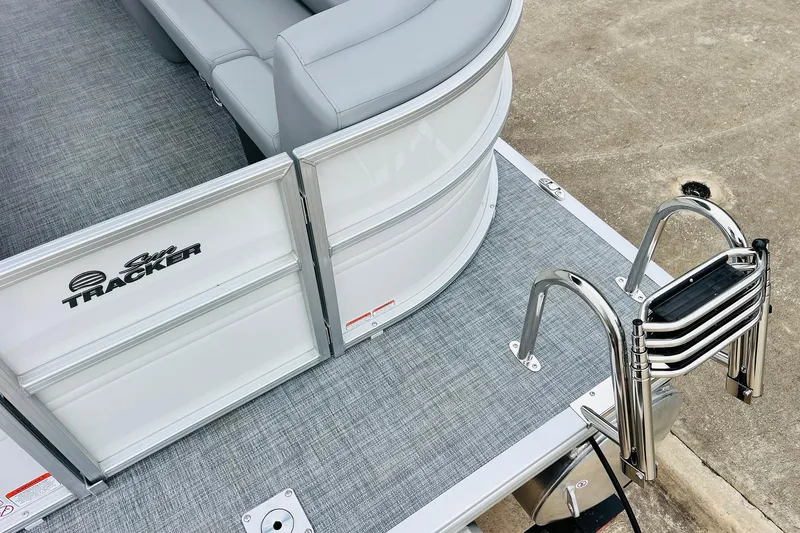 Slide: The Image of 2026 Sun Tracker Party Barge 22 DLX with gray seating and stainless steel ladder. - 14