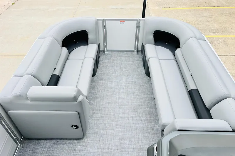 Slide: The Image of 2026 Sun Tracker Party Barge 22 DLX interior with spacious gray seating and modern design. - 16