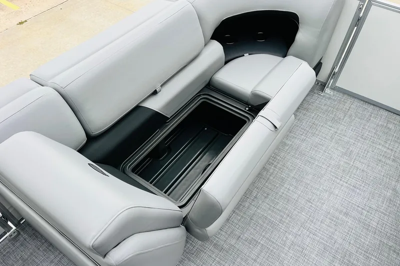 Slide: The Image of 2026 Sun Tracker Party Barge 22 DLX interior seating with storage compartment. - 19