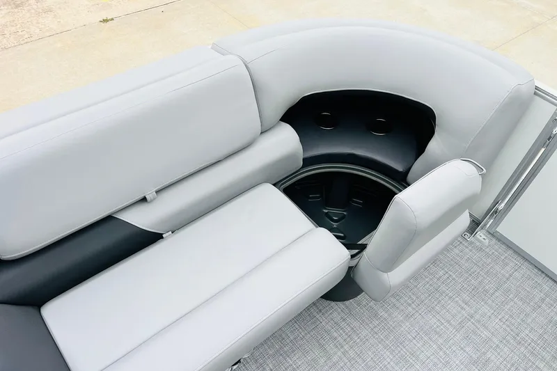 Slide: The Image of 2026 Sun Tracker Party Barge 22 DLX interior with gray seating and storage compartment. - 20