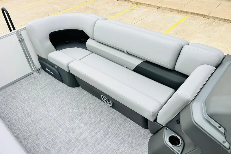 Slide: The Image of 2026 Sun Tracker Party Barge 22 DLX interior with gray seating and cup holders. - 24