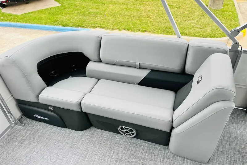 Slide: The Image of 2026 Sun Tracker Party Barge 22 DLX interior seating with gray upholstery and cup holders. - 37