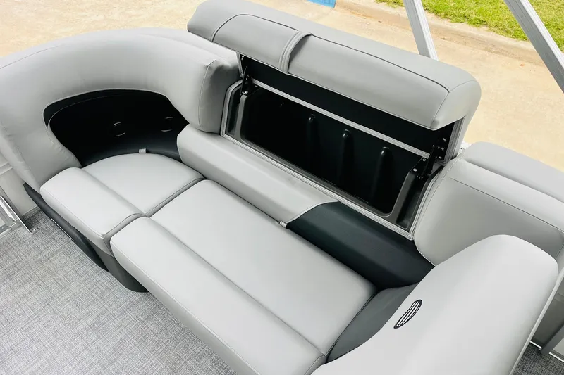 Slide: The Image of 2026 Sun Tracker Party Barge 22 DLX interior with gray seating and storage compartment. - 40