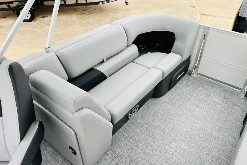 Slide: The Image of 2026 Sun Tracker Party Barge 22 DLX interior with gray seating and carpeted flooring. - 42