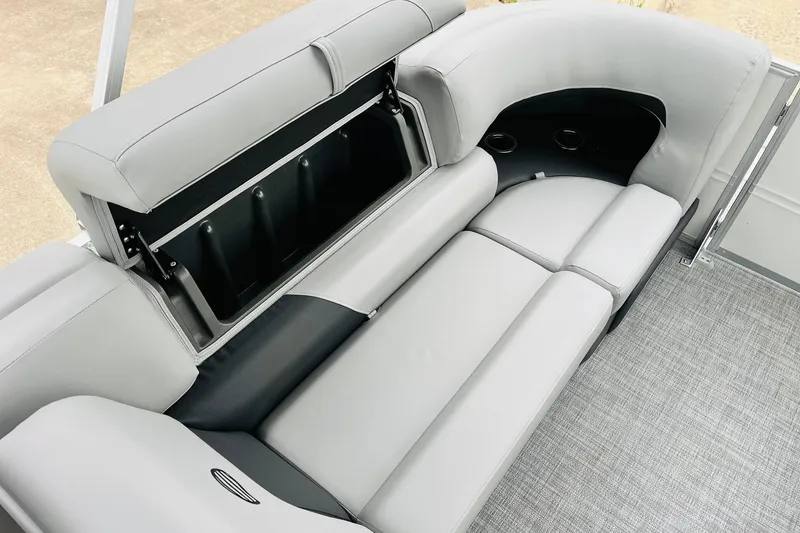 Slide: The Image of 2026 Sun Tracker Party Barge 22 DLX interior with gray seating and storage compartment. - 46
