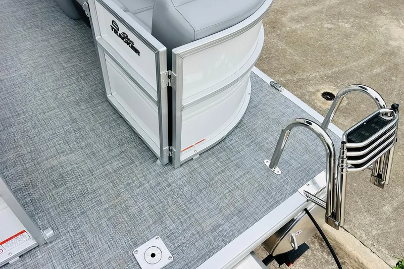 Slide: The Image of 2026 Sun Tracker Party Barge 22 DLX pontoon boat with gray flooring and stainless steel ladder. - 51