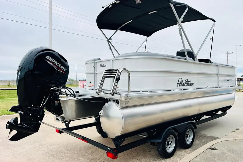 Slide: The Image of 2026 Sun Tracker Party Barge 22 DLX pontoon boat with Mercury outboard motor on trailer. - 6