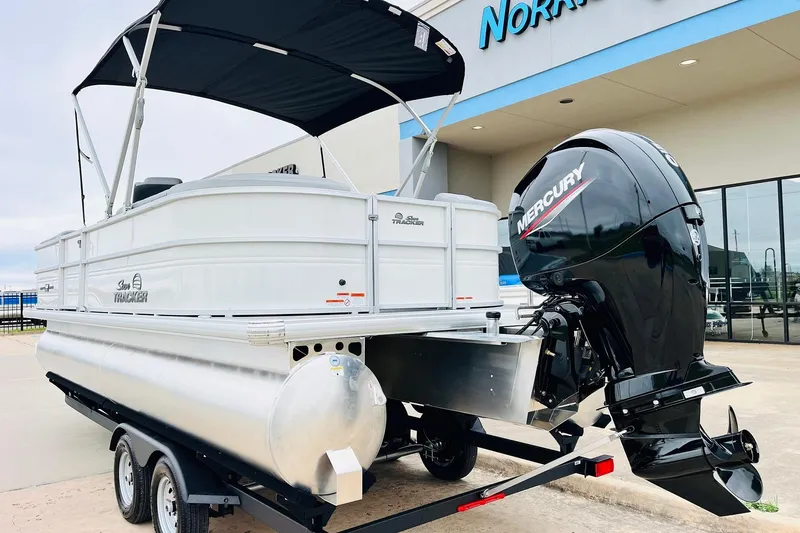 Slide: The Image of 2026 Sun Tracker Party Barge 22 DLX pontoon boat with Mercury outboard motor on trailer. - 8