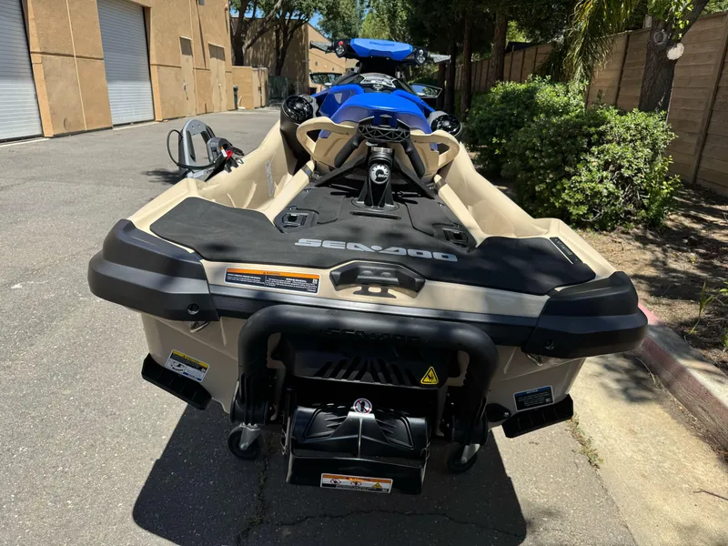 Slide: The Image of 2025 Sea-Doo Wake Pro 230 jet ski parked outdoors, rear view. - 5