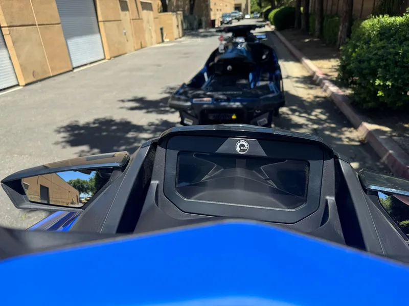 Slide: The Image of 2025 Sea-Doo Wake Pro 230 dashboard view, parked on a sunny street. - 8