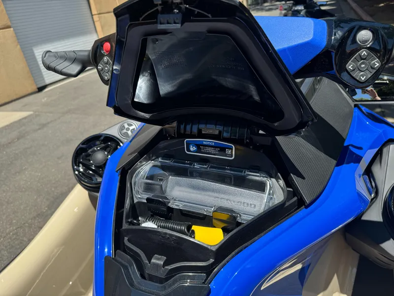 Slide: The Image of 2025 Sea-Doo Wake Pro 230 storage compartment, showcasing handlebar controls and vibrant blue design. - 9