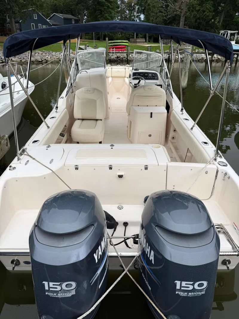 Slide: The Image of 2008 Grady-White Tournament 275 boat with dual Yamaha 150 engines, docked in a serene setting. - 2