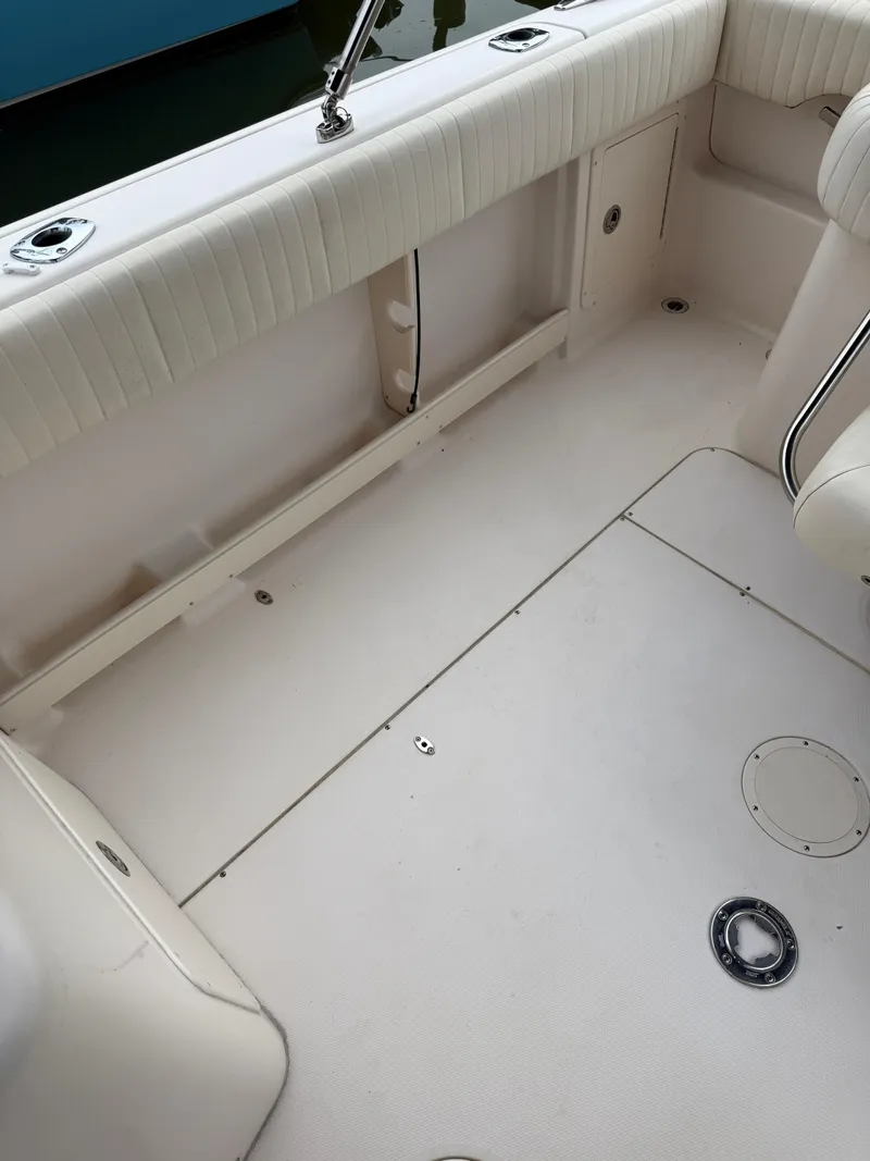 Slide: The Image of 2008 Grady-White Tournament 275 boat interior with white seating and clean deck. - 7