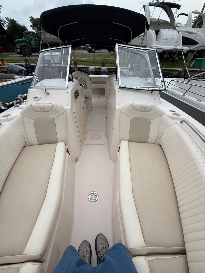 Slide: The Image of 2008 Grady-White Tournament 275 boat interior with beige seating and dual consoles. - 8