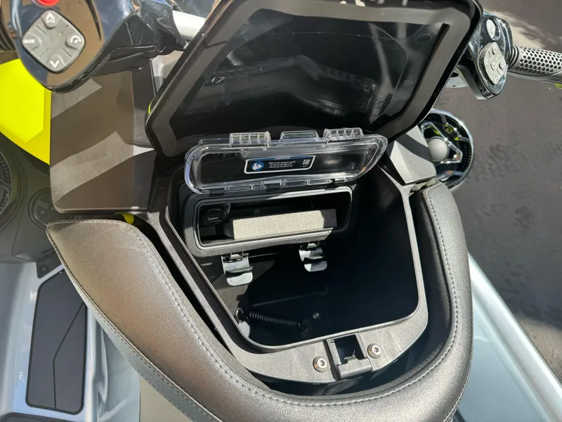 Slide: The Image of 2025 Sea-Doo RXP-X 325 storage compartment with control panel and handlebar details. - 11